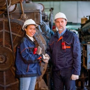 factory-worker-or-technician-stand-and-shake-hands-with-asian-factory-woman-in-front-of-big-machine.jpg